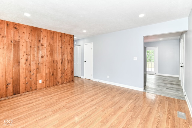 8445 Montery Rd, Indianapolis, IN 46226 - spare room with light wood-style floors, baseboards, recessed lighting, and wooden walls