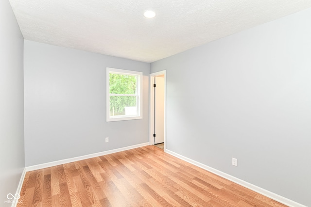 8445 Montery Rd, Indianapolis, IN 46226 - spare room featuring baseboards, light wood-style floors, recessed lighting, and a textured ceiling