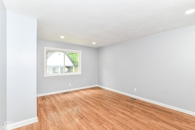 8445 Montery Rd, Indianapolis, IN 46226 - spare room with light wood-style flooring, recessed lighting, baseboards, and a textured ceiling
