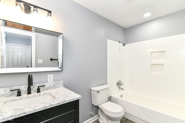 8445 Montery Rd, Indianapolis, IN 46226 - bathroom with vanity, toilet, a textured ceiling, baseboards, and shower / bathtub combination