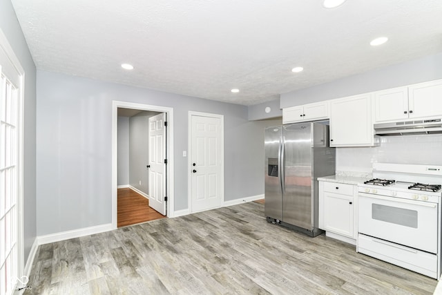 8445 Montery Rd, Indianapolis, IN 46226 - kitchen with stainless steel refrigerator with ice dispenser, white gas stove, under cabinet range hood, white cabinets, and recessed lighting