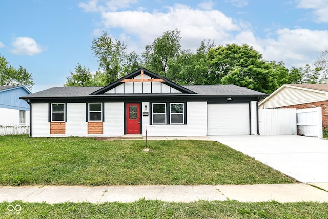 8445 Montery Rd, Indianapolis, IN 46226 - ranch-style home featuring a garage, concrete driveway, brick siding, and a shingled roof