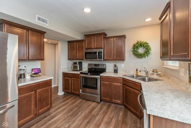 929 Capricorn Dr, Franklin, IN 46131 - kitchen featuring stainless steel appliances, a sink, dark wood-type flooring, light countertops, and recessed lighting