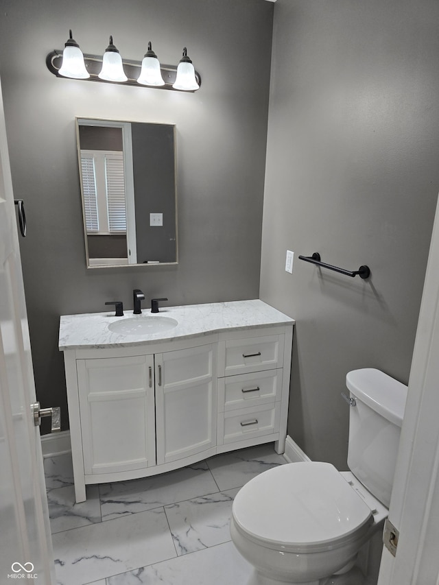 2035 S Pennsylvania St, Indianapolis, IN 46225 - half bath with vanity, marble finish floors, toilet, and baseboards