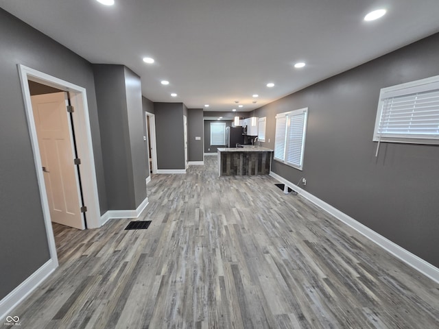 2035 S Pennsylvania St, Indianapolis, IN 46225 - unfurnished living room with wood finished floors, recessed lighting, and baseboards