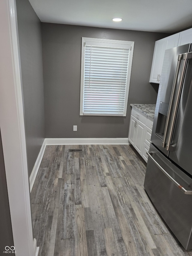 2035 S Pennsylvania St, Indianapolis, IN 46225 - kitchen featuring stainless steel fridge with ice dispenser, white cabinetry, wood finished floors, baseboards, and recessed lighting