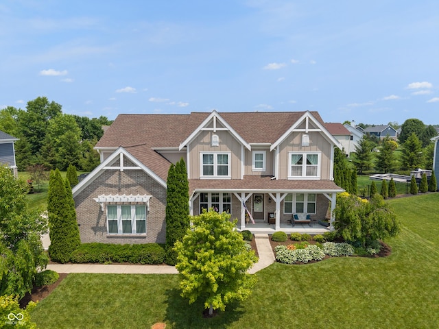 1102 Clearwell Dr, Greenwood, IN 46143 - view of front of house featuring a front lawn, covered porch, board and batten siding, and brick siding