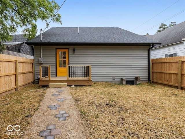 31 Mckenzie St, Shelbyville, IN 46176 - back of house featuring a fenced backyard, a shingled roof, and a deck