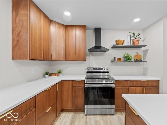 31 Mckenzie St, Shelbyville, IN 46176 - kitchen with electric range, wall chimney range hood, brown cabinetry, light countertops, and recessed lighting