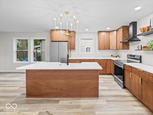 31 Mckenzie St, Shelbyville, IN 46176 - kitchen featuring stainless steel appliances, wall chimney range hood, a sink, light wood-style floors, and brown cabinetry