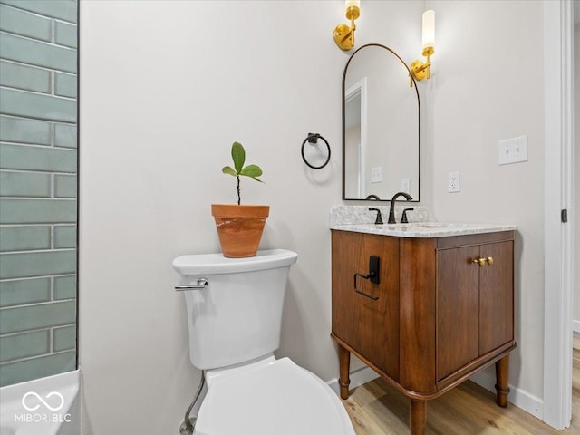 31 Mckenzie St, Shelbyville, IN 46176 - bathroom with vanity, toilet, wood finished floors, and baseboards
