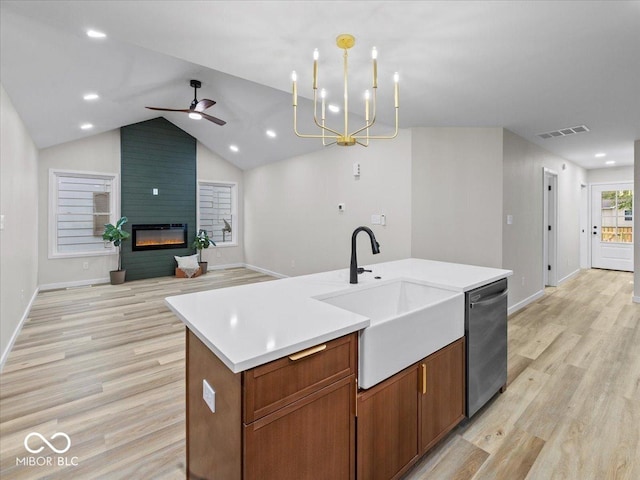 31 Mckenzie St, Shelbyville, IN 46176 - kitchen featuring a sink, dishwasher, open floor plan, light wood-type flooring, and vaulted ceiling