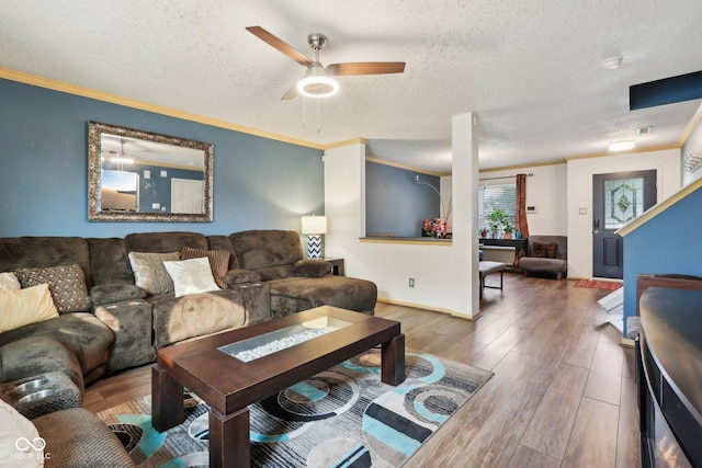 2887 Ludwig Dr, Indianapolis, IN 46239 - living area with a textured ceiling, wood finished floors, ornamental molding, a ceiling fan, and baseboards