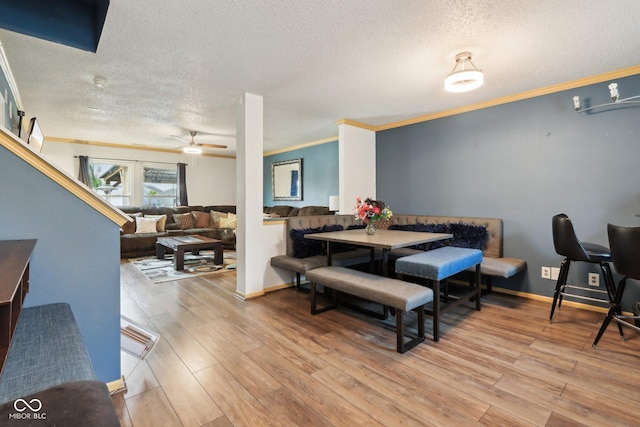 2887 Ludwig Dr, Indianapolis, IN 46239 - dining area with a textured ceiling, ceiling fan, light wood-style floors, crown molding, and baseboards