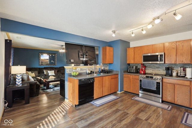 2887 Ludwig Dr, Indianapolis, IN 46239 - kitchen with appliances with stainless steel finishes, a sink, dark wood finished floors, open floor plan, and decorative backsplash