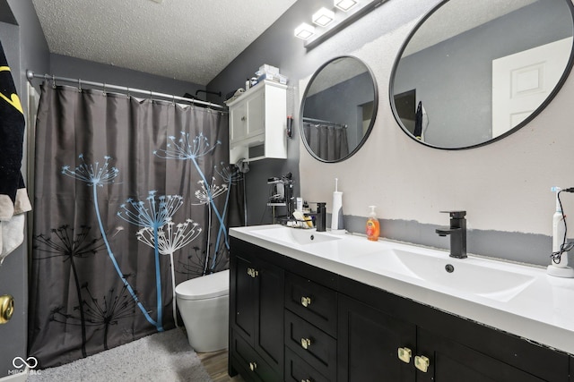 2887 Ludwig Dr, Indianapolis, IN 46239 - bathroom featuring toilet, double vanity, a textured ceiling, and a shower with curtain