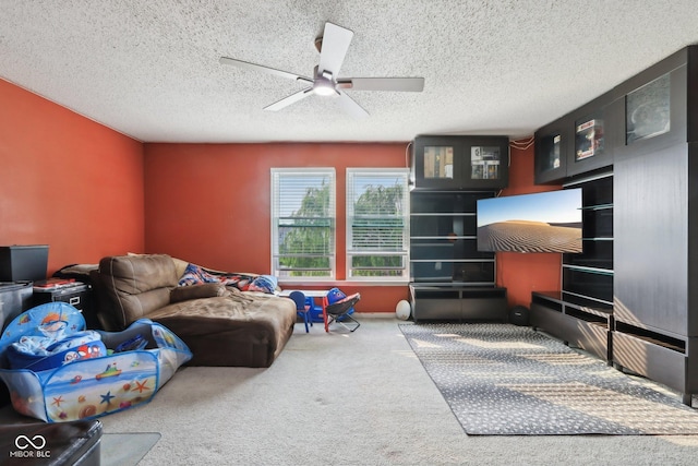 2887 Ludwig Dr, Indianapolis, IN 46239 - living area with carpet flooring, ceiling fan, and a textured ceiling