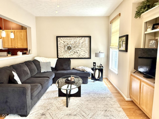 7042 Gavin Dr, Indianapolis, IN 46217 - living area with light wood finished floors and a textured ceiling