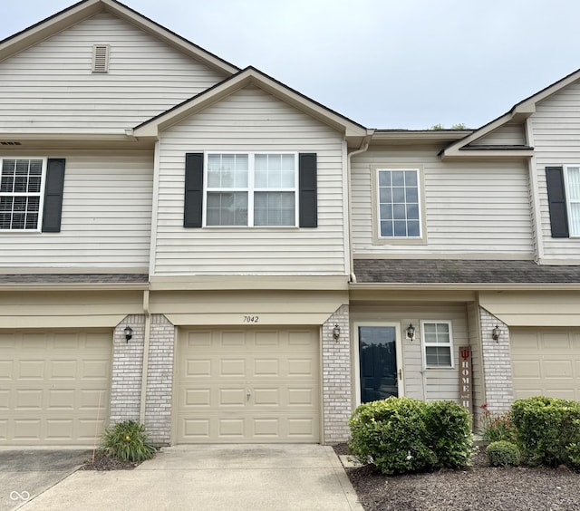 7042 Gavin Dr, Indianapolis, IN 46217 - multi unit property featuring brick siding, a garage, and concrete driveway
