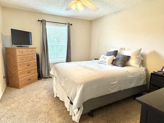 7042 Gavin Dr, Indianapolis, IN 46217 - bedroom with light carpet, a textured ceiling, and a ceiling fan