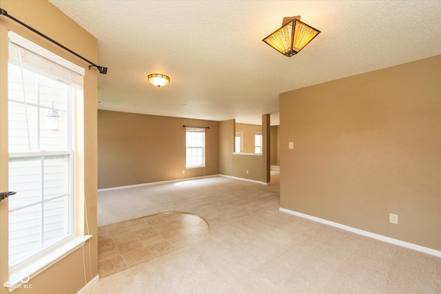 12671 Endurance Dr, Fishers, IN 46037 - unfurnished room with light colored carpet, baseboards, and a textured ceiling
