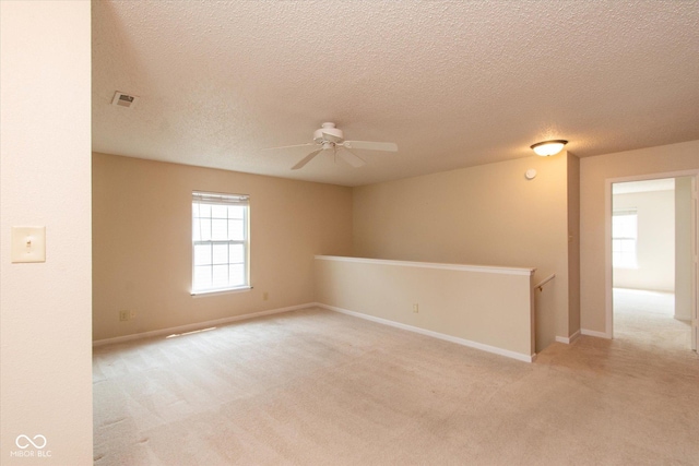 12671 Endurance Dr, Fishers, IN 46037 - spare room with a ceiling fan, a textured ceiling, light colored carpet, and baseboards