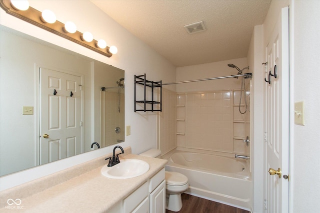 12671 Endurance Dr, Fishers, IN 46037 - bathroom featuring vanity, toilet, a textured ceiling,  shower combination, and wood finished floors