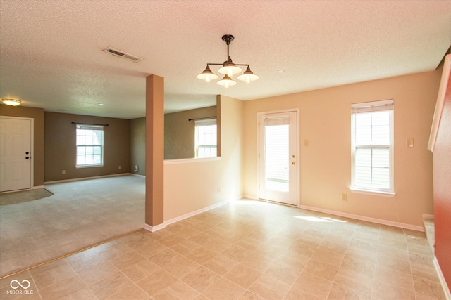 12671 Endurance Dr, Fishers, IN 46037 - unfurnished room featuring a textured ceiling, baseboards, light carpet, and a chandelier