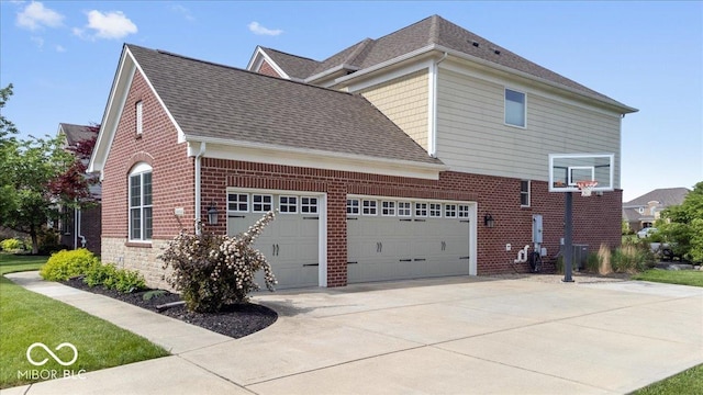 10054 Win Star Way, Fishers, IN 46040 - view of property exterior featuring brick siding, driveway, a garage, and roof with shingles