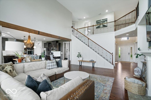 10054 Win Star Way, Fishers, IN 46040 - living area featuring a high ceiling, stairs, a chandelier, dark wood-style flooring, and recessed lighting