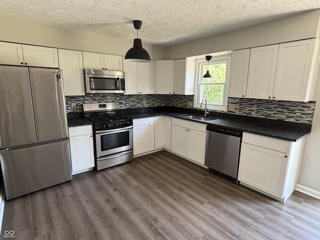 4343 W Fairview Rd, Greenwood, IN 46142 - kitchen featuring appliances with stainless steel finishes, dark countertops, white cabinets, and a textured ceiling