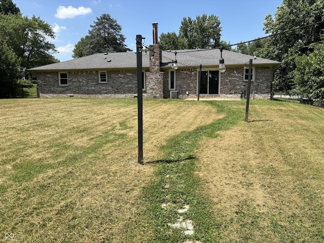 4343 W Fairview Rd, Greenwood, IN 46142 - rear view of property with a lawn, brick siding, and a chimney