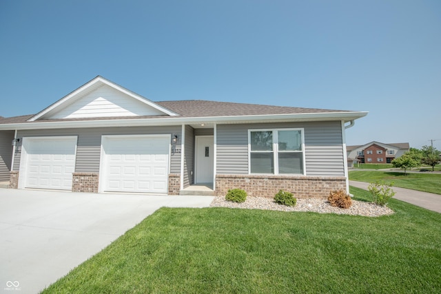1452 Coen Ct, Columbus, IN 47201 - view of front of property with brick siding, an attached garage, concrete driveway, and a front lawn