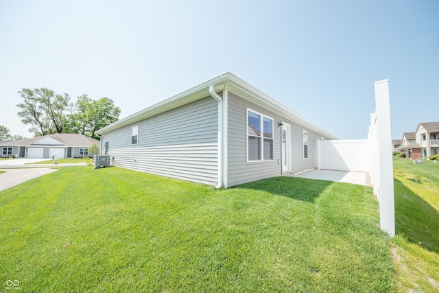 1452 Coen Ct, Columbus, IN 47201 - view of property exterior featuring a lawn and central air condition unit