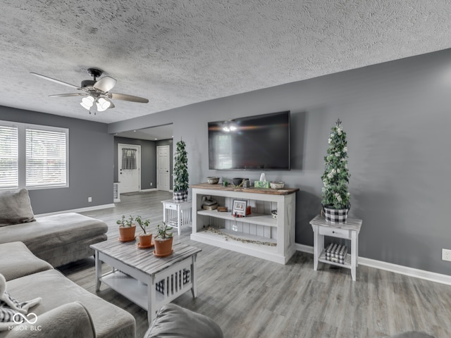 730 N Forsythe St, Franklin, IN 46131 - living room featuring baseboards, wood finished floors, a ceiling fan, and a textured ceiling