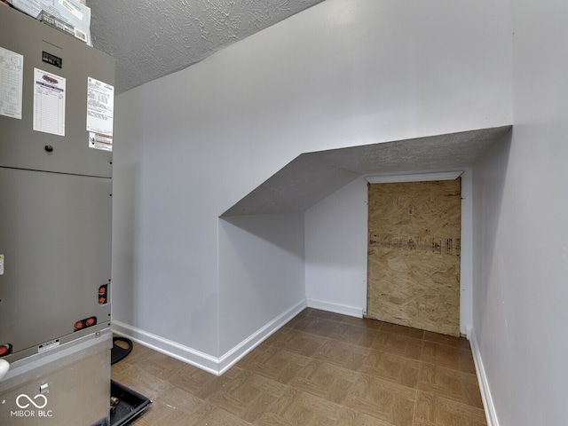 730 N Forsythe St, Franklin, IN 46131 - additional living space with heating unit, baseboards, and a textured ceiling