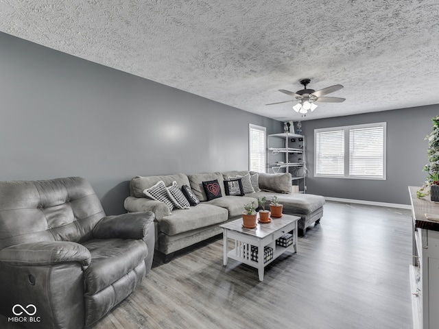 730 N Forsythe St, Franklin, IN 46131 - living room with wood finished floors, a ceiling fan, baseboards, and a textured ceiling