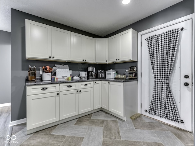 730 N Forsythe St, Franklin, IN 46131 - kitchen featuring white cabinetry, baseboards, dark stone counters, and recessed lighting