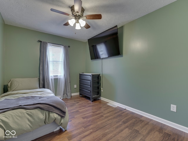 730 N Forsythe St, Franklin, IN 46131 - bedroom with wood finished floors, a textured ceiling, baseboards, and a ceiling fan