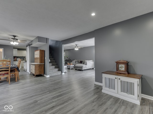 730 N Forsythe St, Franklin, IN 46131 - living area featuring a ceiling fan, baseboards, wood finished floors, stairs, and recessed lighting
