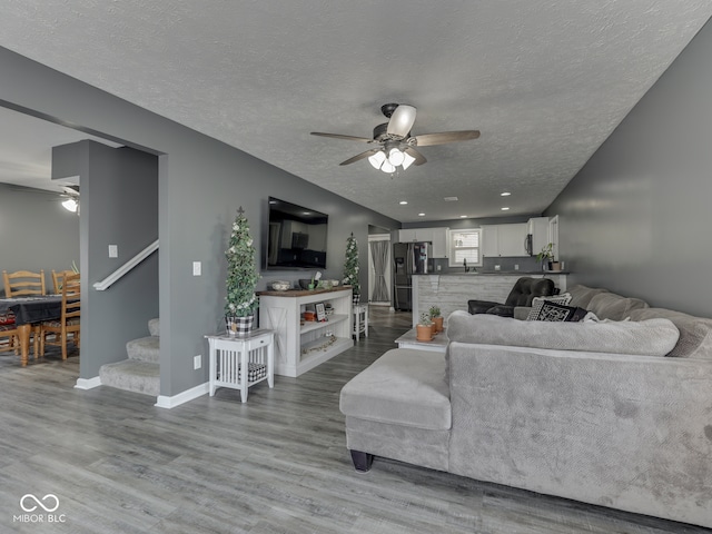 730 N Forsythe St, Franklin, IN 46131 - living room with a ceiling fan, stairway, wood finished floors, a textured ceiling, and baseboards