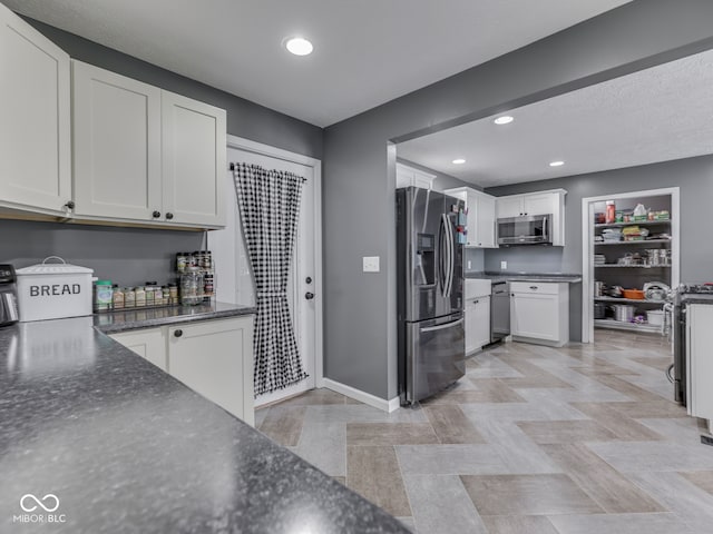 730 N Forsythe St, Franklin, IN 46131 - kitchen with appliances with stainless steel finishes, white cabinets, baseboards, recessed lighting, and dark stone counters