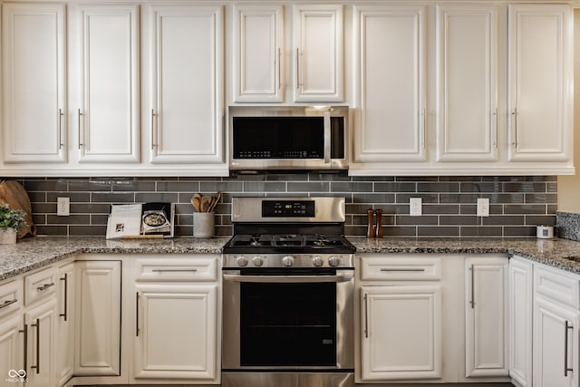 2016 Central Ave, Indianapolis, IN 46202 - kitchen featuring stainless steel appliances, white cabinetry, tasteful backsplash, and light stone countertops