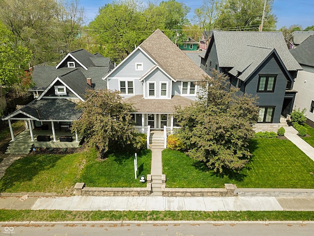 2016 Central Ave, Indianapolis, IN 46202 - view of front of property featuring a porch, a front yard, a shingled roof, and a residential view