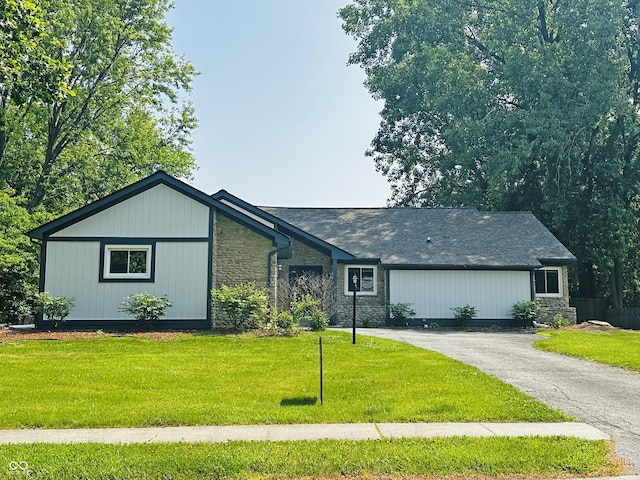 723 Bennett Rd, Carmel, IN 46032 - view of front facade with stone siding, a front lawn, and driveway