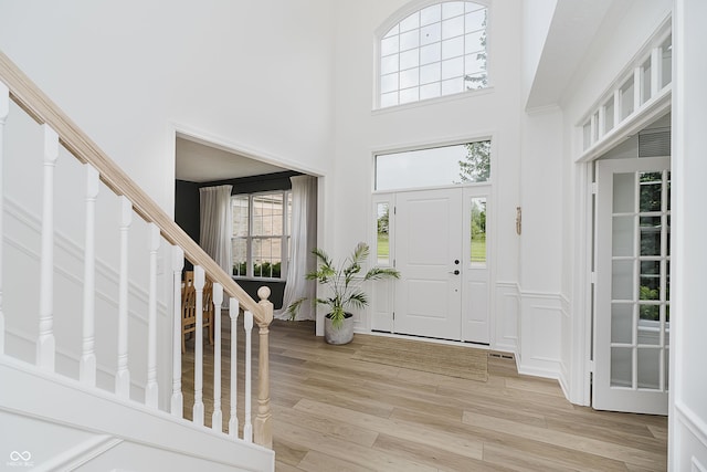 3876 Kegler Way, Carmel, IN 46074 - entryway featuring a towering ceiling, light wood-style floors, and stairs