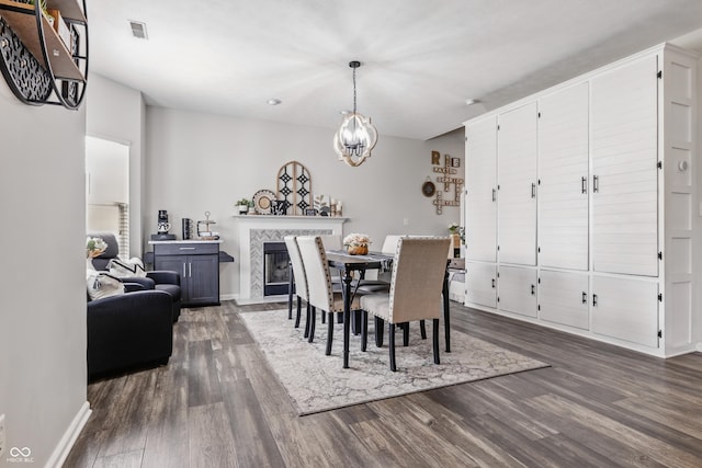5030 E 800 N, Columbus, IN 47203 - dining area featuring dark wood finished floors, baseboards, a fireplace, and a chandelier