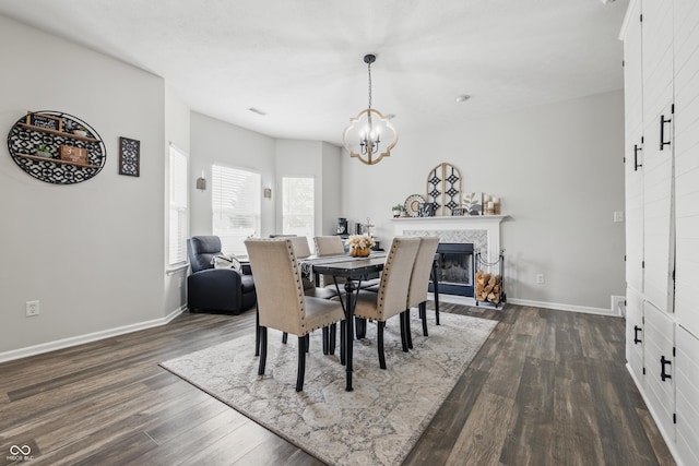5030 E 800 N, Columbus, IN 47203 - dining space featuring dark wood-style flooring, a chandelier, baseboards, and a fireplace
