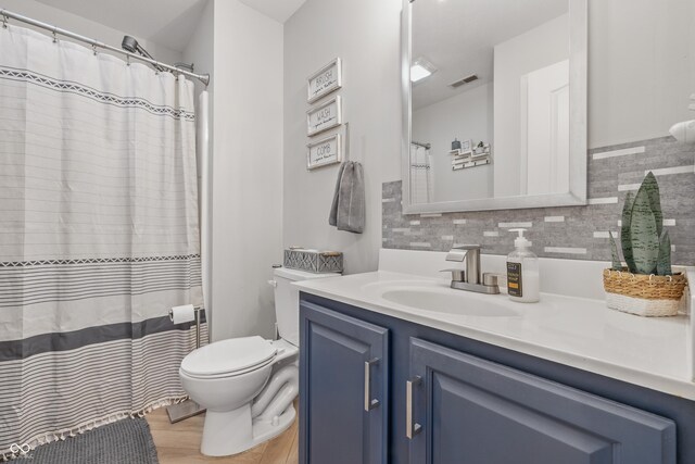 5030 E 800 N, Columbus, IN 47203 - bathroom featuring toilet, vanity, backsplash, wood finished floors, and curtained shower
