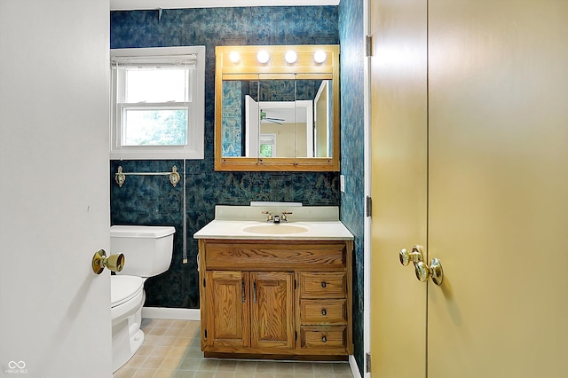 13172 E 116th St, Fishers, IN 46037 - half bathroom featuring baseboards, vanity, toilet, and wallpapered walls